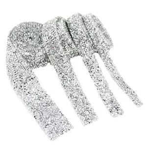 Close-up detail of silver rhinestone ribbon trim, sparkling crystal hot fix mesh DIY.
