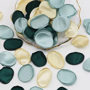 Artificial silk rose petals detail shot showing mixed green and yellow fabric wedding party decor.