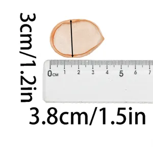 Detail shot of orange mesh decorative petal with clear ruler showing dimensions for party DIY.