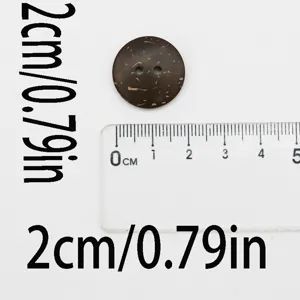 Detail view of 2cm wooden coconut button with two holes for sewing and DIY craft projects.