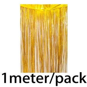Gold tinsel foil curtain detail showing shiny metallic fringes for party background setup.