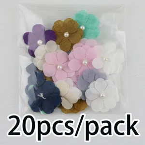 Detail view of multi-color fabric five-petal flower patches with pearl center for DIY crafts.