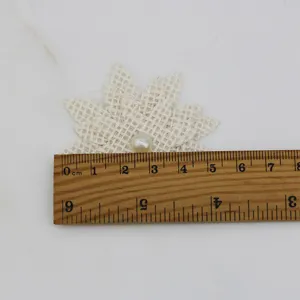 Burlap flower detail shot showing size with ruler, fabric DIY craft accessory nicely.