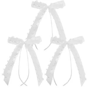 White heart edge ribbon bow detail shot, elegant handmade wedding and party decoration craft.