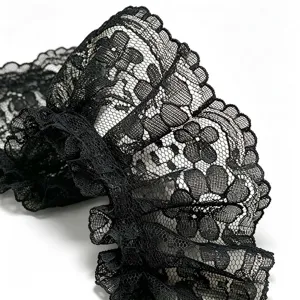 Detailed close-up of black pleated lace trim with delicate floral pattern, ideal for DIY sewing crafts.