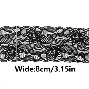 Detail view of black elastic lace trim, showing delicate floral pattern and fabric texture.
