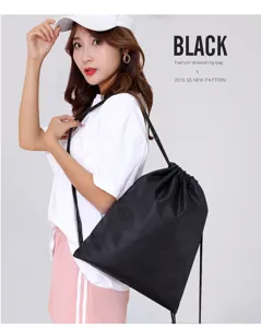 Detail view of black waterproof oxford cloth drawstring backpack with stylish soccer texture.