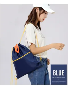 Oxford cloth drawstring backpack, blue casual daypack with yellow straps and front zip pocket.