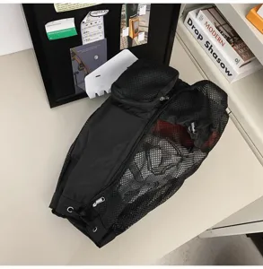 Gym mesh drawstring backpack detail showing breathable fabric and zipper pocket design.