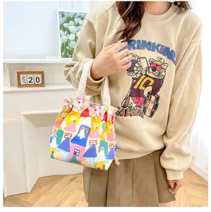 Detailed view of the colorful house pattern canvas lunch bag with drawstring and handle.