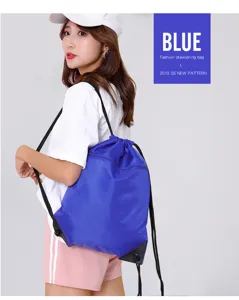 Detailed shot of a blue drawstring backpack worn by an Asian model in studio setting clearly.
