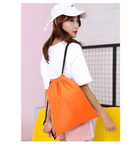Bright orange waterproof oxford drawstring backpack shown worn by model from behind.