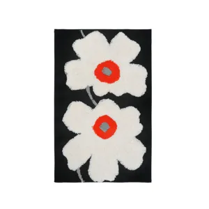 Tufted black area rug featuring white poppy flower design, non-slip floor mat for home.