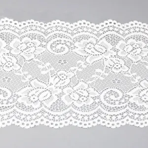 Detailed view of white elastic lace trim, 15cm wide floral fabric for sewing DIY crafts.