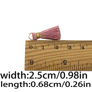 Mini pink tassel charm with gold thread wrap and metal ring for DIY jewelry and straps.