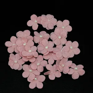 Detail view of 2.5cm pink 5-petal fabric flower patches with pearl center for DIY sewing.