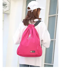 Pink drawstring backpack detail, multifunctional sports gym bag with mesh pockets.