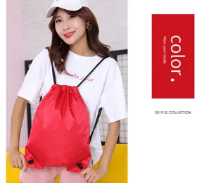 Red Oxford cloth drawstring backpack detail showing the spacious sport gym sack design.