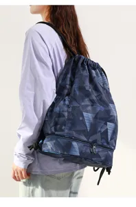 Detail of dry-wet separation swim backpack with tie-dye pattern and bottom compartment.