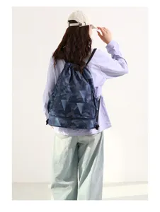 Blue geometric drawstring backpack with bottom wet dry compartment for travel and gym use.