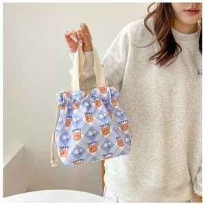 Detailed view of the cute blue plaid lunch bag with cartoon bear print and convenient drawstring.