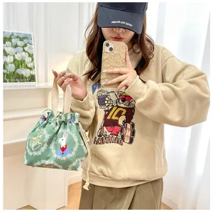 Detailed view of the cute Japanese style rabbit print drawstring lunch bag with soft handles.