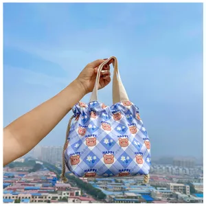 Cute cartoon bear print drawstring lunch bag detail view, canvas bento tote with handle.