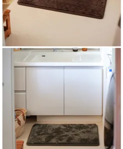 Detailed view of the thick flannel striped floor mat placed in front of the bathroom sink.