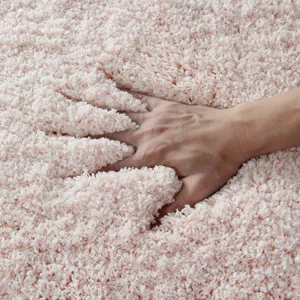Pink fluffy shaggy bath mat, thick absorbent microfiber tufted rug for cozy bathroom floor.