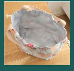 Waterproof Japanese bento lunch bag with cute cat pattern and convenient drawstring closure.