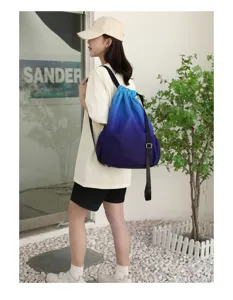 Gradient drawstring backpack detail, waterproof nylon fabric, casual travel sports bag.