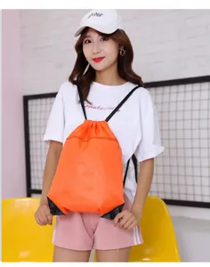 Orange drawstring backpack for outdoor travel, lightweight portable casual daypack bag now.