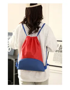 Detail view of the colorful drawstring backpack showing front zipper pocket and shoulder straps.