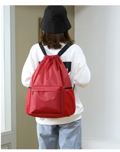 Red drawstring backpack with front pocket and mesh side pockets, perfect for sports fitness.