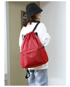 Red oxford cloth drawstring backpack for women, lightweight travel daypack and gym sports bag.
