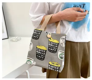 Detail shot of cute canvas lunch bag with coffee pattern and sturdy handles for office.