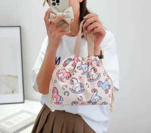 Detailed view of pink cute rocking horse print canvas drawstring bento lunch bag with handles.