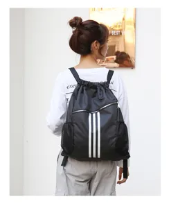 Black drawstring backpack with three stripes, large capacity sports gym bag for men and women.