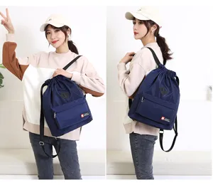 Waterproof drawstring backpack for men and women, lightweight sports gym sackpack with front pocket.