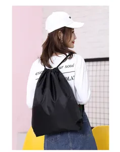 Black polyester drawstring backpack lightweight gym cinch bag for daily travel and sports.