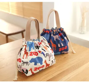 Close-up of cute animal print canvas lunch bento bags with convenient drawstring closure.