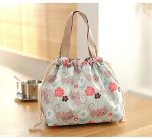 Cute Japanese canvas bento lunch bag with cat print and convenient drawstring closure.