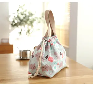 Cute cat pattern canvas lunch bag detail showing drawstring closure and durable fabric handles.
