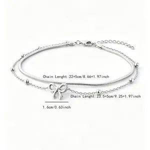 Macro detail view showing the measurements of a stainless steel double-layer bow anklet
