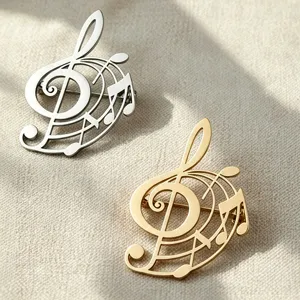 Close-up of gold and silver treble clef musical note brooches on textured fabric