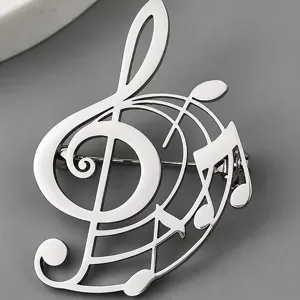 Detailed macro view of a silver stainless steel G-clef music note brooch with pin