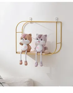 Elegant gold metal wall shelf with wooden base displaying decorative cat figurines
