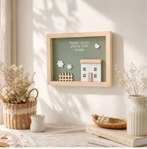 Close-up of wooden frame wall art with 3D house and 'There is no place like home' text