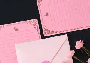 Pink stationery set with envelope and letter paper, elegant design for romantic letters.