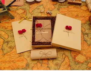 Vintage kraft paper stationery gift box set with envelopes and romantic red rose decoration.